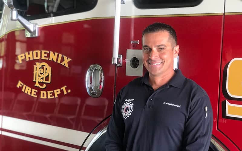 Jason standing in front of a fire engine